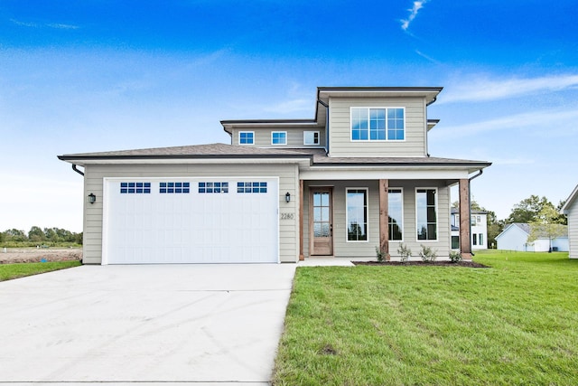 view of front of property featuring a garage, a front lawn, and a porch