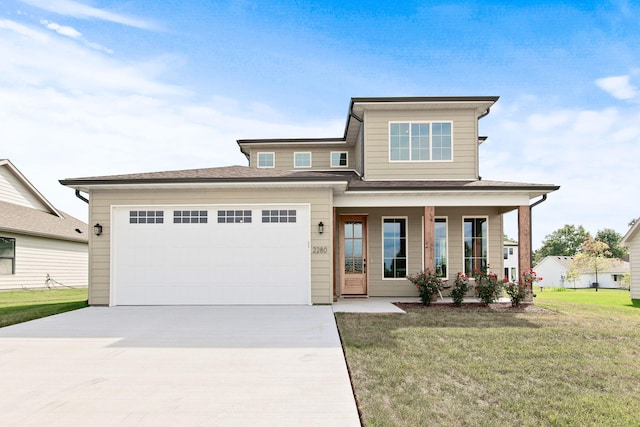 view of front of home with a front yard, a garage, and a porch