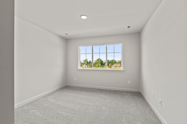 unfurnished room featuring a textured ceiling and carpet floors