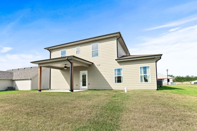 back of property with a yard and a patio area