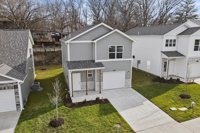 view of front facade with cooling unit, a garage, and a front yard