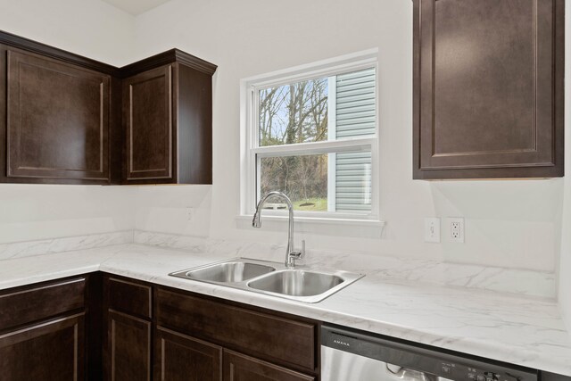 kitchen with dishwasher, dark brown cabinetry, and sink