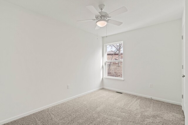 carpeted spare room with ceiling fan