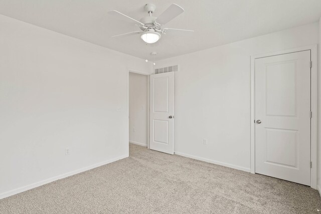 spare room featuring ceiling fan and light colored carpet