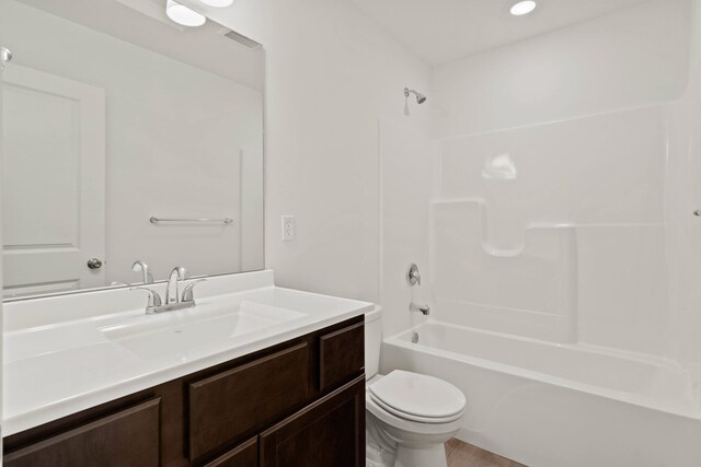 full bathroom featuring vanity,  shower combination, and toilet