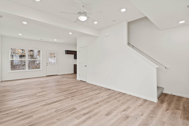 unfurnished living room with ceiling fan and light hardwood / wood-style floors