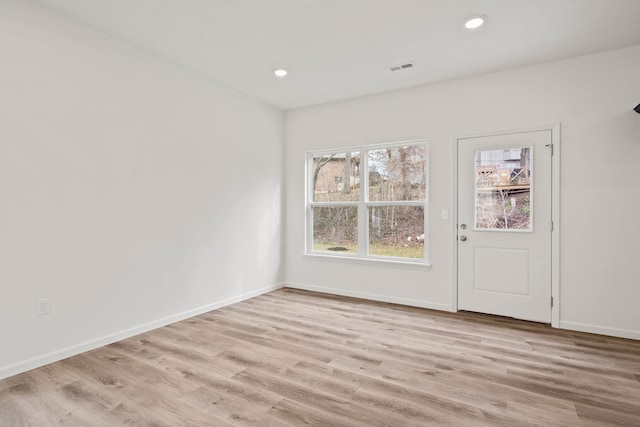 unfurnished room with light wood-type flooring