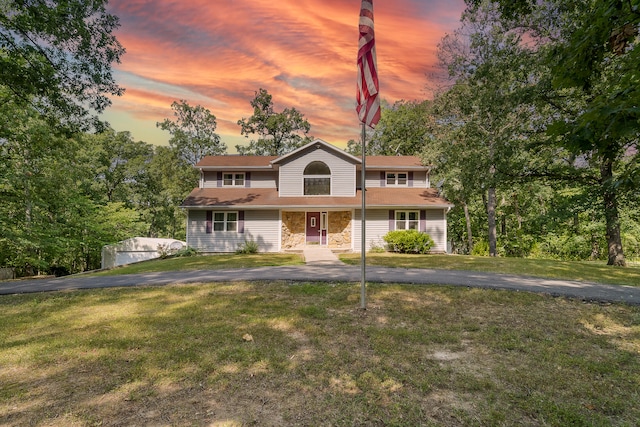 view of front of property featuring a yard and a garage