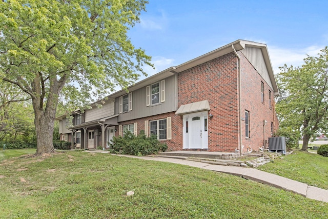 view of front of property featuring a front lawn and central air condition unit