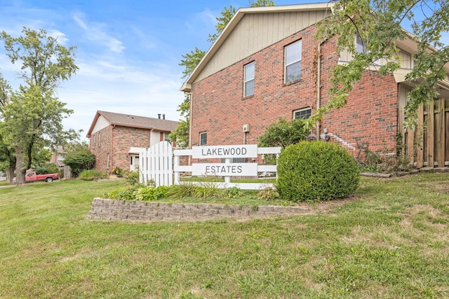 community / neighborhood sign with a lawn