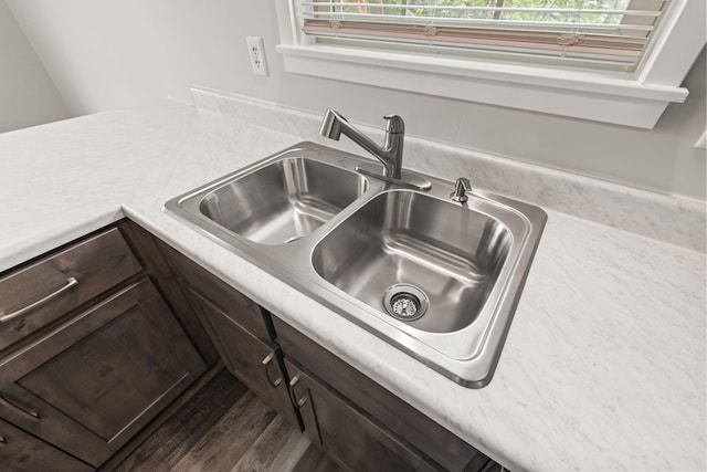 details with dark brown cabinetry and sink