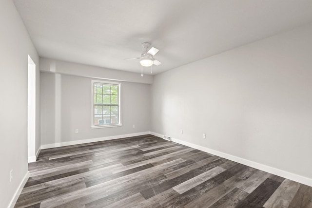 unfurnished room with ceiling fan and dark hardwood / wood-style flooring