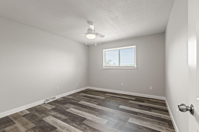 unfurnished room featuring ceiling fan, dark wood-type flooring, and a textured ceiling