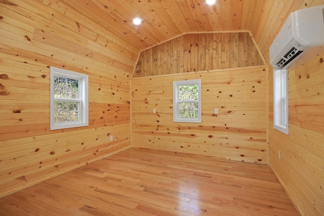 empty room featuring wooden ceiling, a healthy amount of sunlight, lofted ceiling, and wooden walls