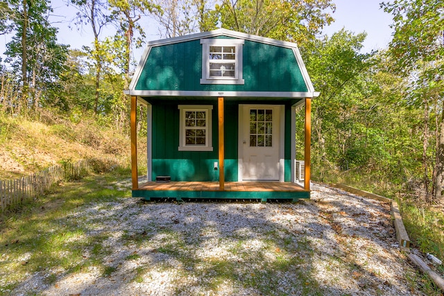 view of outbuilding with fence and an outdoor structure