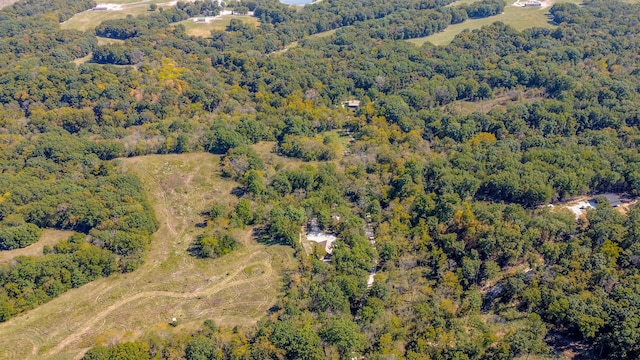 birds eye view of property featuring a view of trees