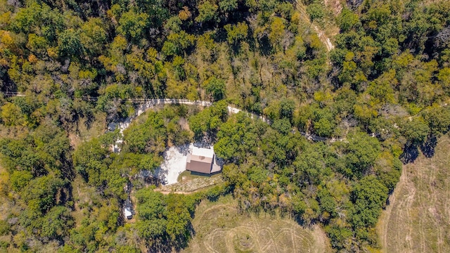 birds eye view of property with a forest view