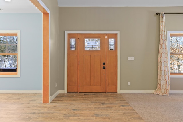 entrance foyer featuring light wood finished floors and baseboards