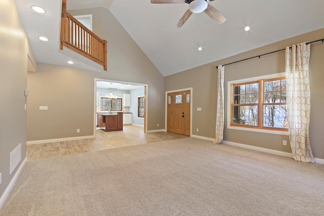 unfurnished living room featuring high vaulted ceiling, recessed lighting, light carpet, a ceiling fan, and baseboards