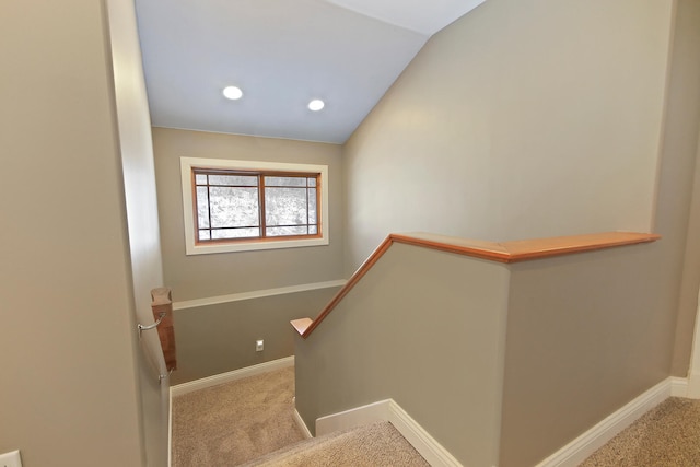 stairs featuring carpet, vaulted ceiling, and baseboards