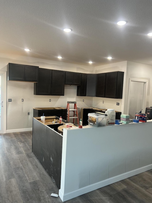 kitchen with hardwood / wood-style flooring and a textured ceiling