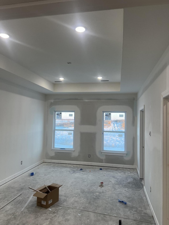 spare room featuring a tray ceiling