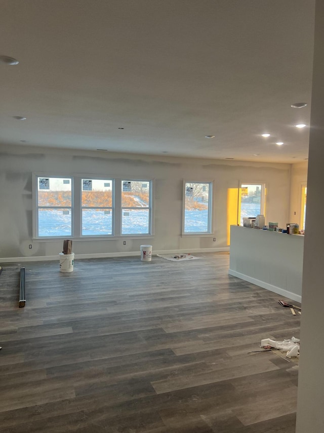 unfurnished living room with dark hardwood / wood-style flooring