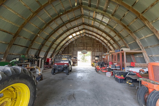 interior space featuring vaulted ceiling and concrete floors