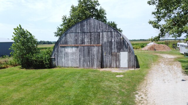 view of outbuilding featuring a lawn