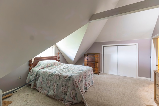 bedroom with carpet, a closet, and lofted ceiling