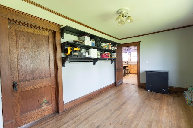 bedroom featuring an inviting chandelier, ornamental molding, and hardwood / wood-style flooring