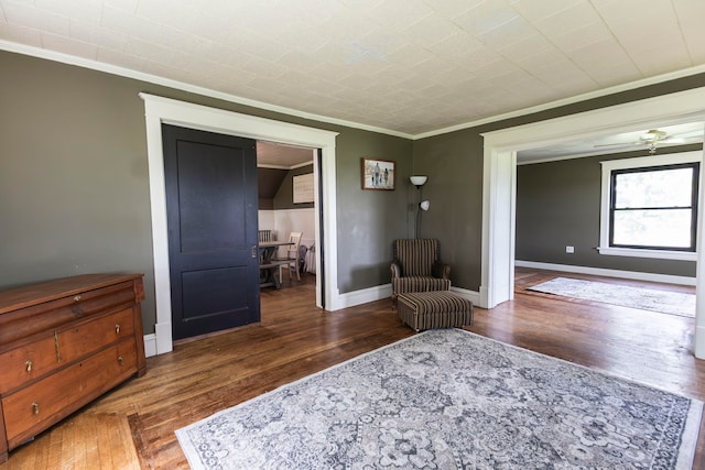 living area with ornamental molding and dark hardwood / wood-style floors