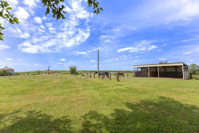 view of yard with a rural view and an outdoor structure