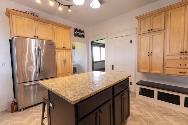 kitchen featuring a center island, high end refrigerator, light parquet flooring, and track lighting