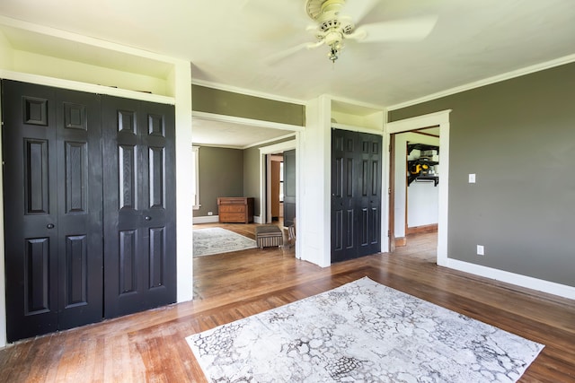 entryway with ceiling fan, ornamental molding, and hardwood / wood-style flooring