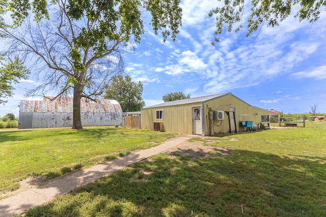 rear view of house with a yard