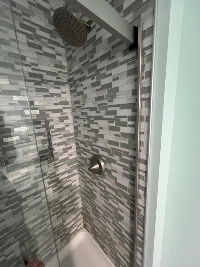 bathroom with tiled shower