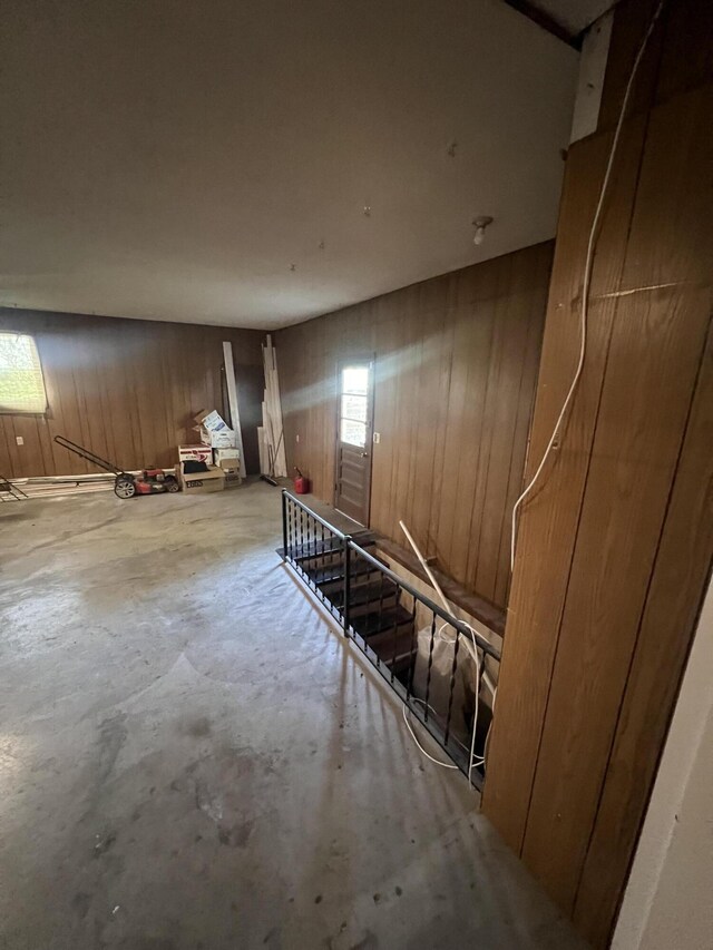 basement featuring wooden walls