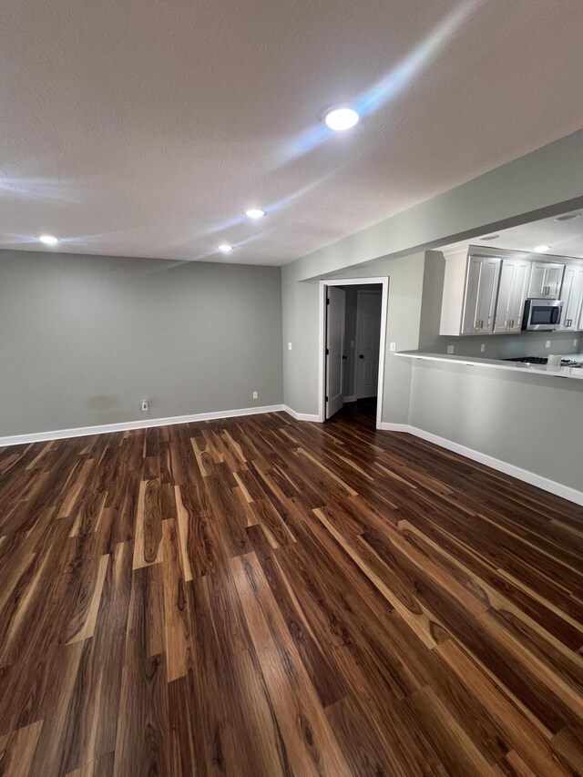 basement with a textured ceiling and hardwood / wood-style flooring