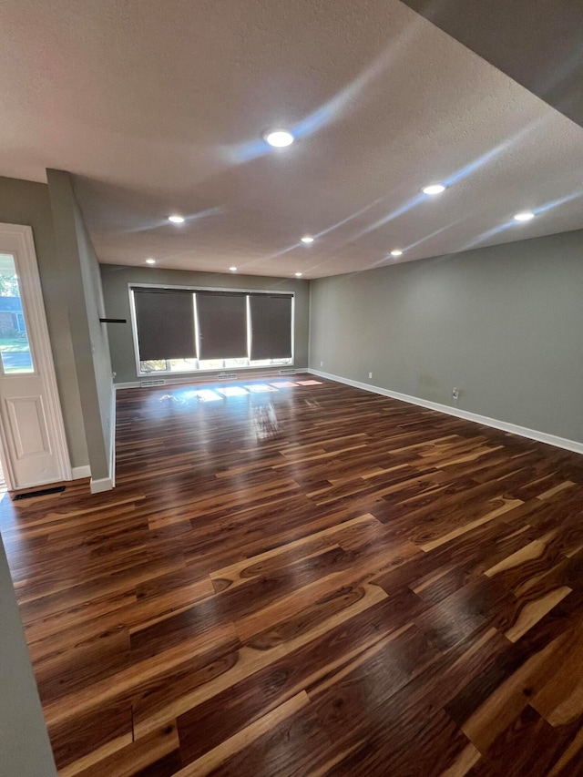 interior space featuring dark hardwood / wood-style floors and a textured ceiling