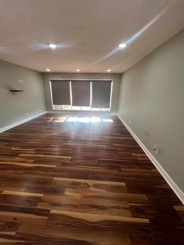 empty room with dark wood-type flooring