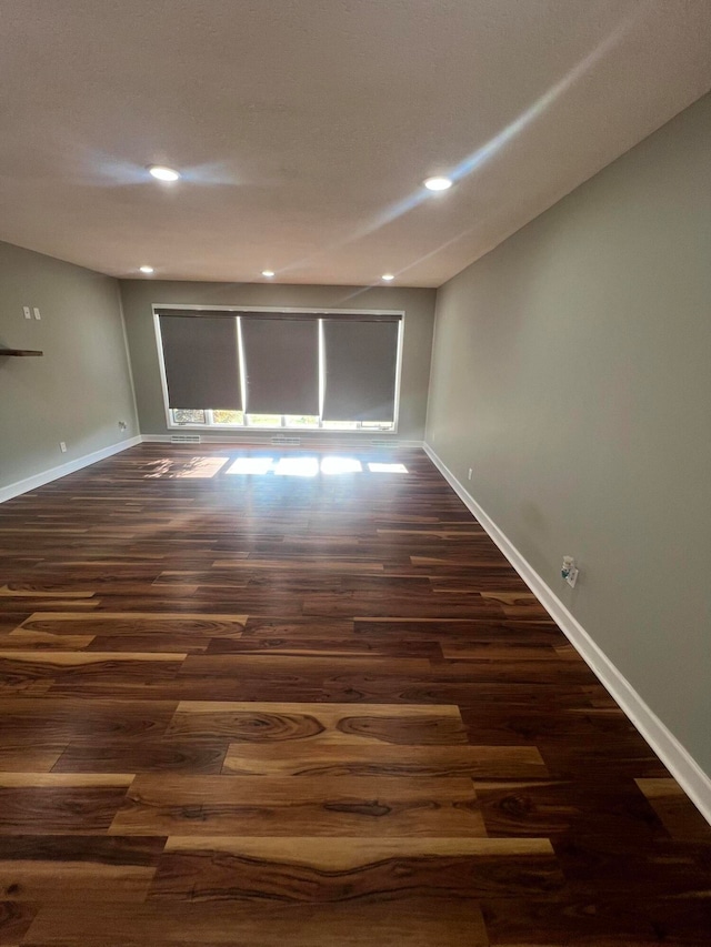 spare room with dark hardwood / wood-style flooring