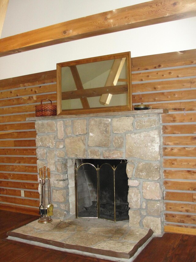 interior details with a stone fireplace and hardwood / wood-style flooring