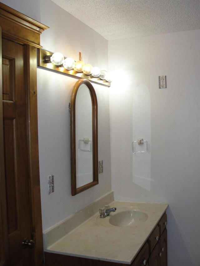 bathroom featuring vanity and a textured ceiling