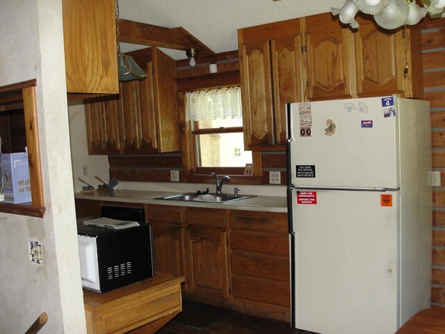 kitchen with white refrigerator and sink