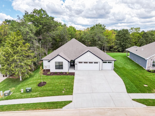 view of front of house featuring a garage and a front lawn