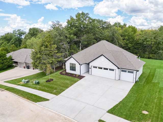 view of front of home with a garage and a front yard