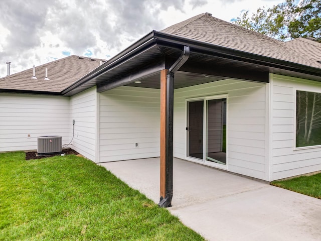 back of property featuring a lawn, a patio, and cooling unit