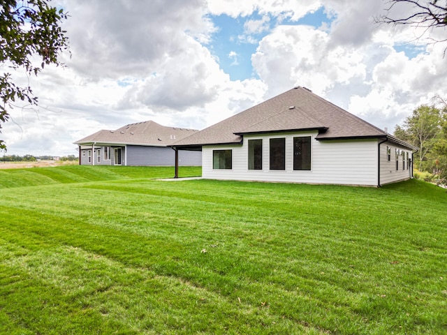 back of property featuring a lawn