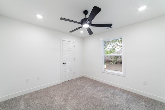 spare room featuring ceiling fan and carpet